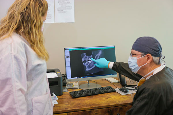 Dental Assistant reviewing an x-ray at Singing River Dentistry