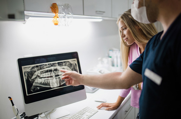 Dentist reviewing a digital x-ray at Singing River Dentistry